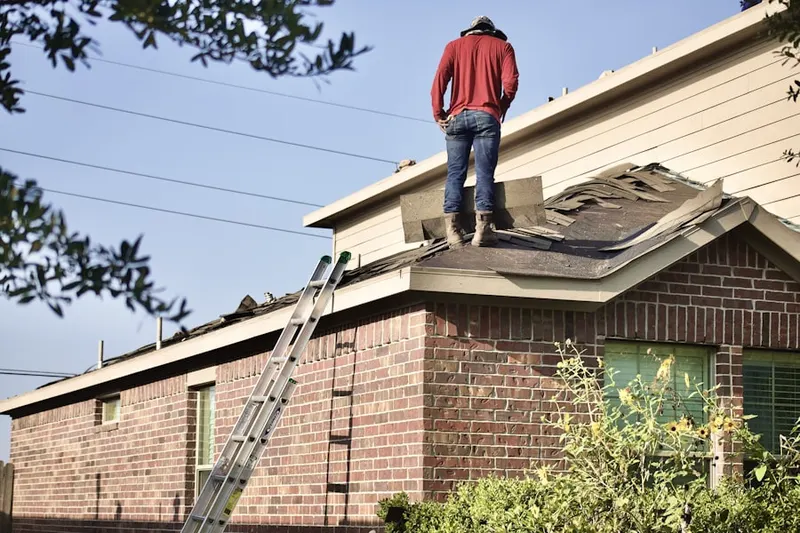 Professional roofer working on a residential roof in Irvington
